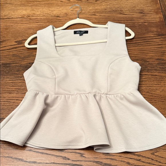 our 12th young contemorary Tops - Elegant Cream Sleeveless Peplum Top